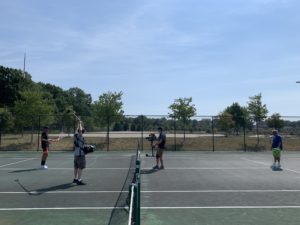 athletic video shoot Camera crew on tennis court
